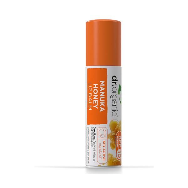 Bálsamo labial Mel de Manuka Bio em stick cilíndrico branco, com tampa laranja e indicação SPF 15 na embalagem.
