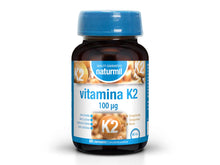 Frasco castanho de Vitamina K2 Naturmil 100 µg, com tampa azul e rótulo azul e branco, contendo 60 comprimidos.