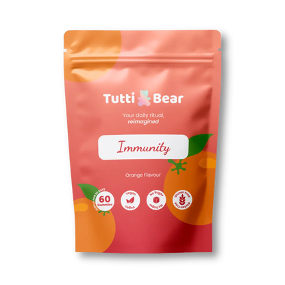 Embalagem flexível rosa e laranja de Gomas de Imunidade TuttiBear, sabor a laranja, com 60 gomas veganas.